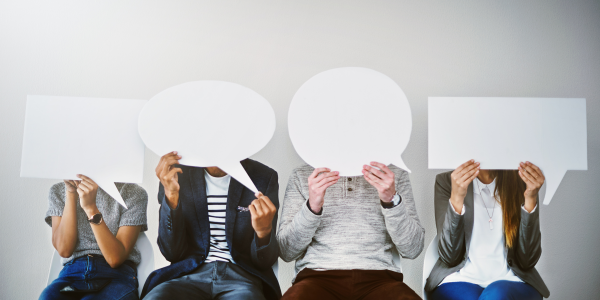 Diverse group of people, each holding a different speech bubble cardboard cut out