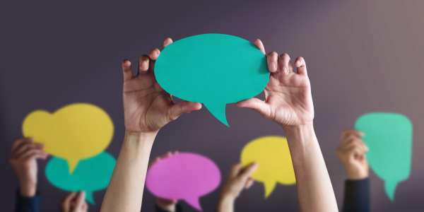 hands holding paper speech bubbles