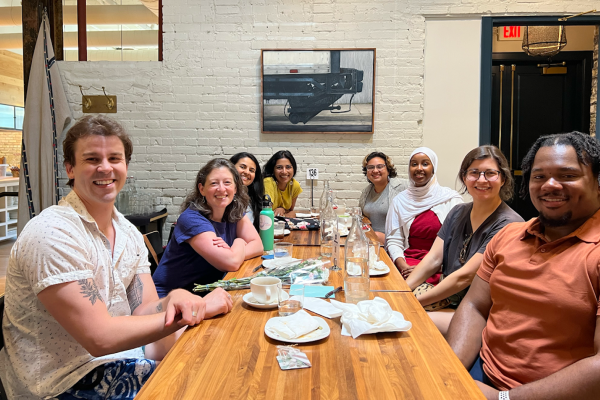 UMN team sitting together at a table