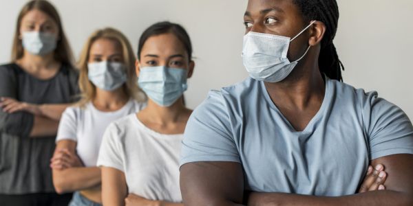diverse group of people in line wearing masks