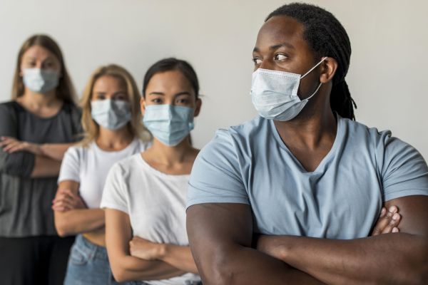 diverse group of people in line wearing masks