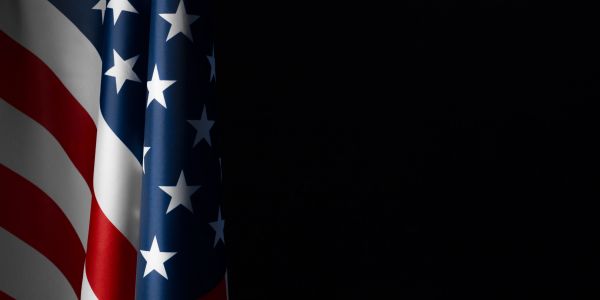 American flag hanging on a chalkboard