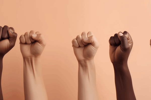 diverse group of fists raised up into the air