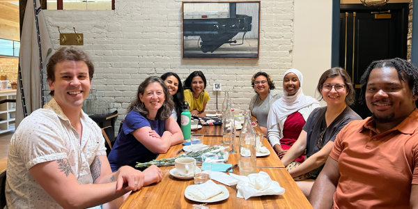 UMN team sitting together at a table