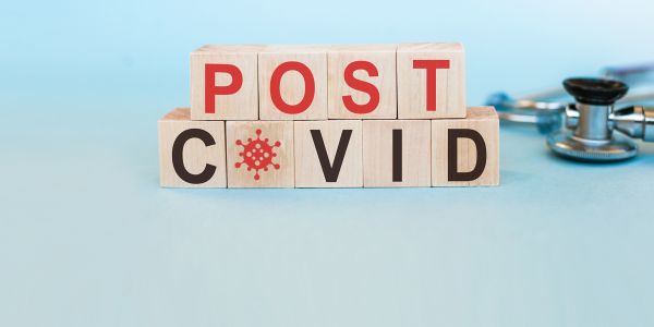 wooden blocks with letters that spell out "post covid"