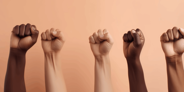 diverse group of fists raised up into the air