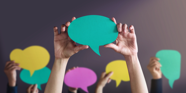 hands holding paper speech bubbles