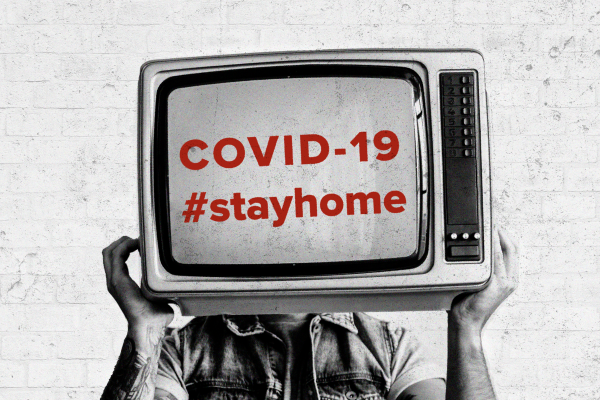 Man holding vintage TV with COVID-19 text label